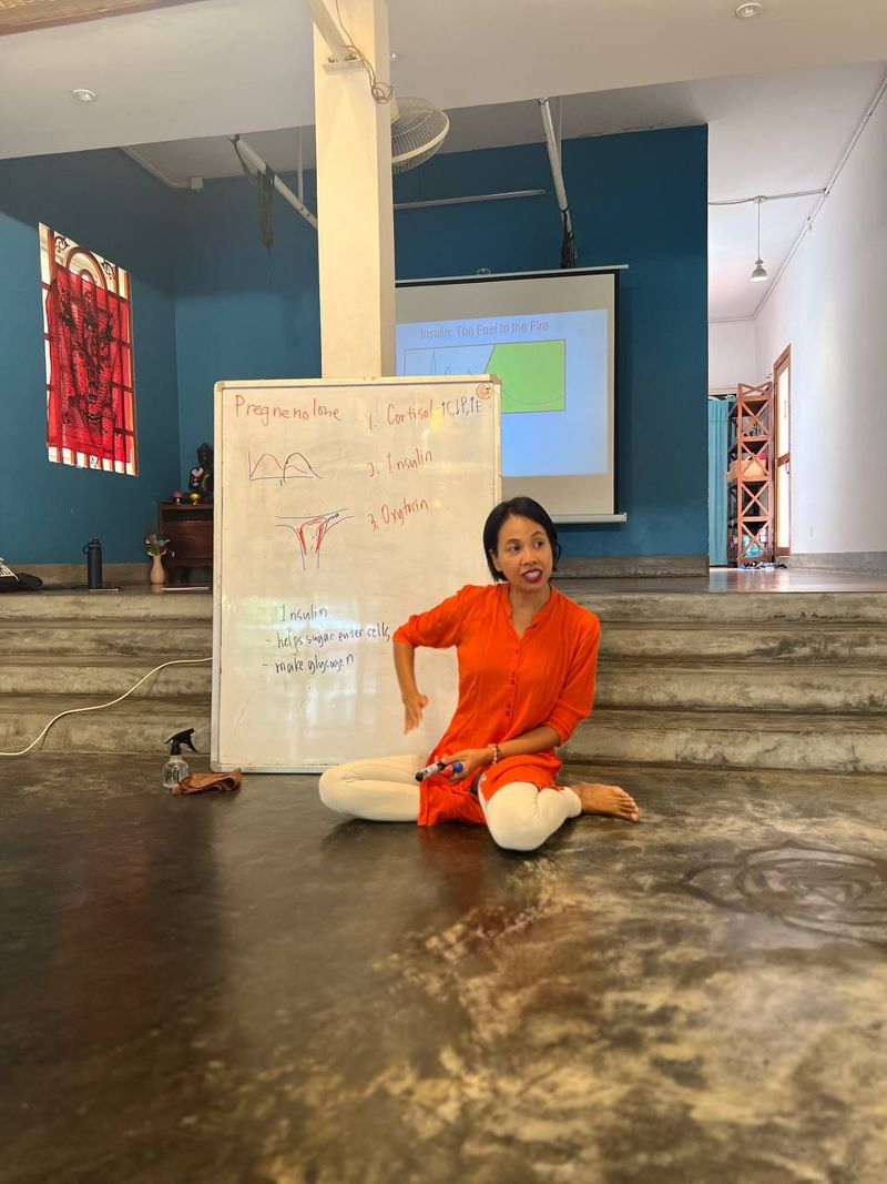 Elizabeth teaching at a whiteboard